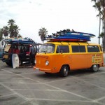 VW Bus piled high with surfboards